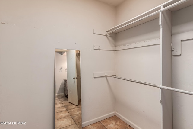 spacious closet featuring light tile patterned flooring