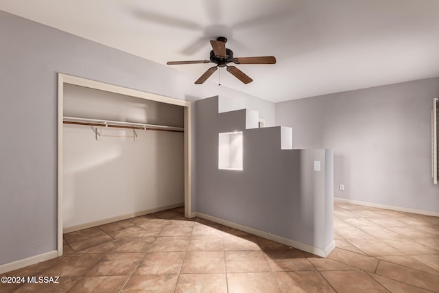 interior space with light tile patterned floors, a closet, and ceiling fan