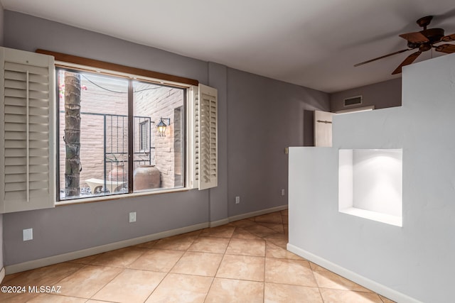 tiled empty room with ceiling fan