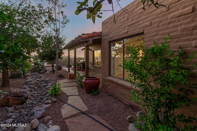 yard at dusk featuring a patio