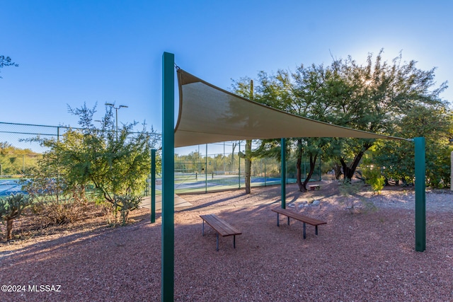 surrounding community featuring tennis court