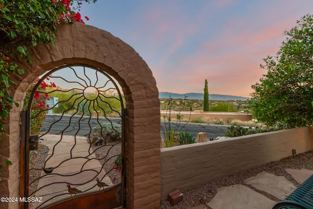 gate at dusk with a mountain view