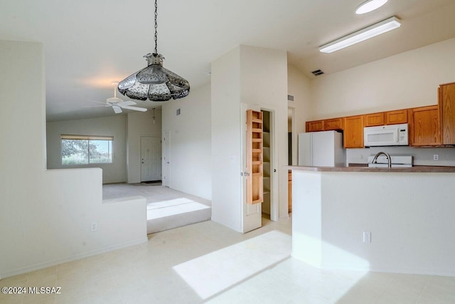 kitchen with pendant lighting, ceiling fan, white appliances, and vaulted ceiling