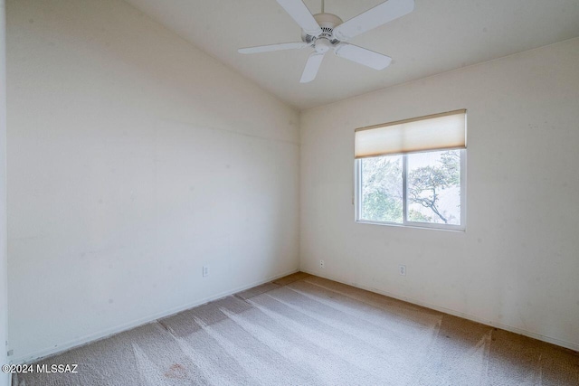 carpeted empty room with ceiling fan and vaulted ceiling