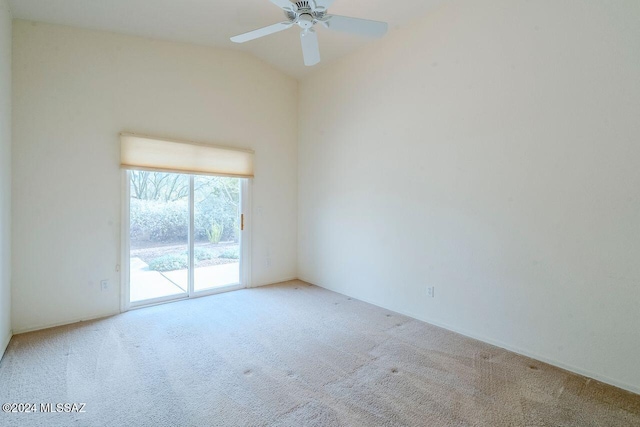 spare room with light carpet, vaulted ceiling, and ceiling fan