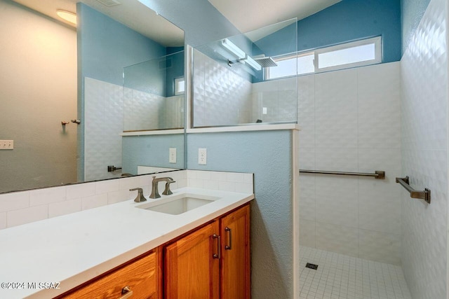 bathroom featuring vanity and a tile shower