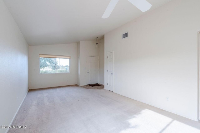 carpeted empty room with ceiling fan and vaulted ceiling