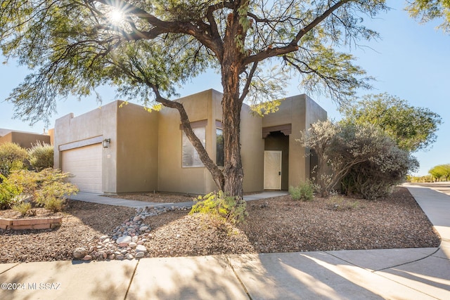 pueblo-style house with a garage