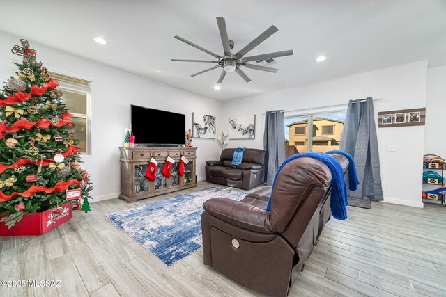 living room featuring ceiling fan and light hardwood / wood-style floors