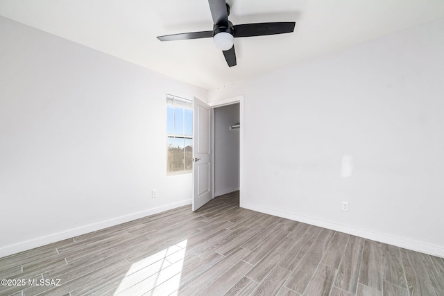 unfurnished room featuring ceiling fan and light wood-type flooring