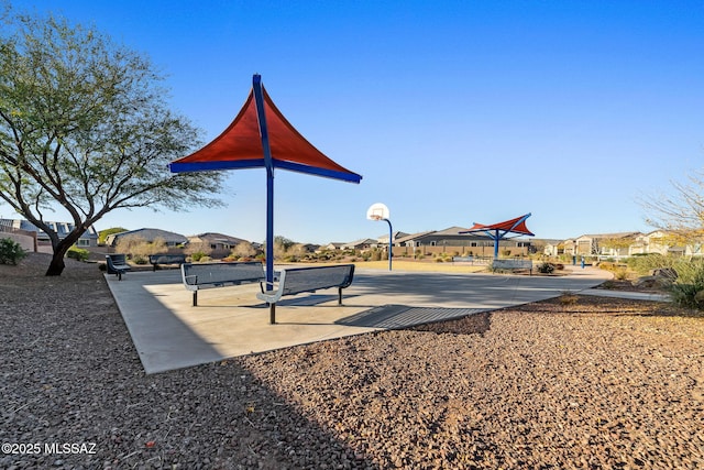 view of community with basketball hoop