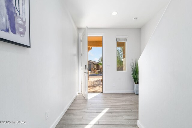 hall with light hardwood / wood-style flooring