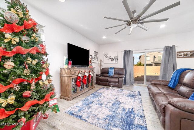 living room featuring ceiling fan and light wood-type flooring