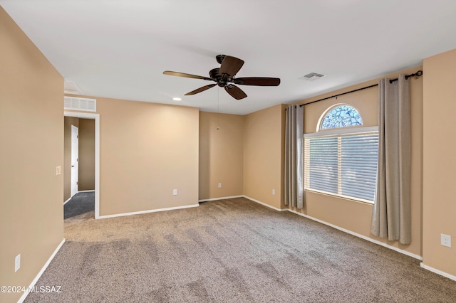 carpeted spare room with ceiling fan