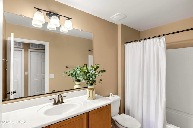 full bathroom featuring shower / bath combo, vanity, and toilet