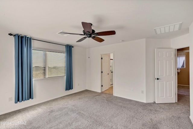 unfurnished room featuring light carpet and ceiling fan