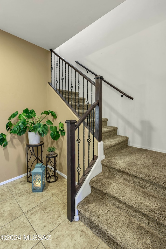 stairs featuring tile patterned flooring