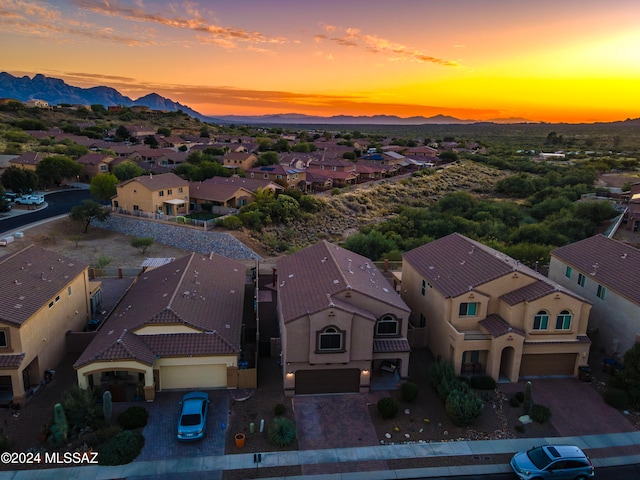 aerial view at dusk featuring a mountain view