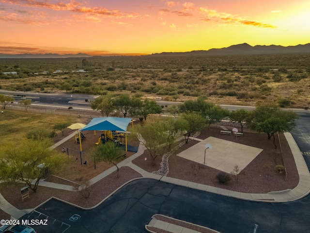 aerial view at dusk featuring a mountain view