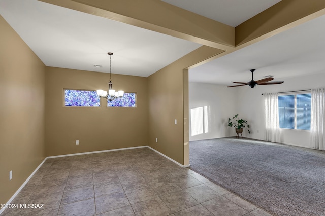 carpeted spare room with ceiling fan with notable chandelier and a wealth of natural light