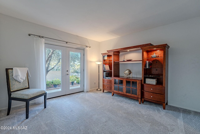 living area with light colored carpet and french doors