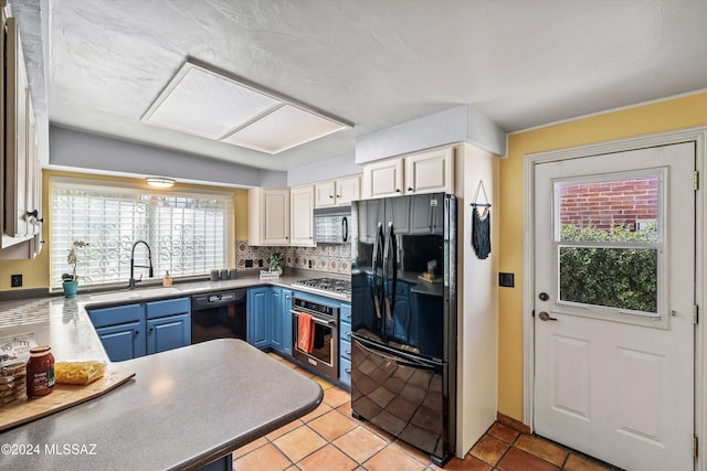 kitchen with blue cabinetry, backsplash, a healthy amount of sunlight, and black appliances