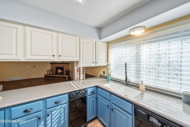 kitchen featuring blue cabinetry, white cabinetry, dishwasher, and sink