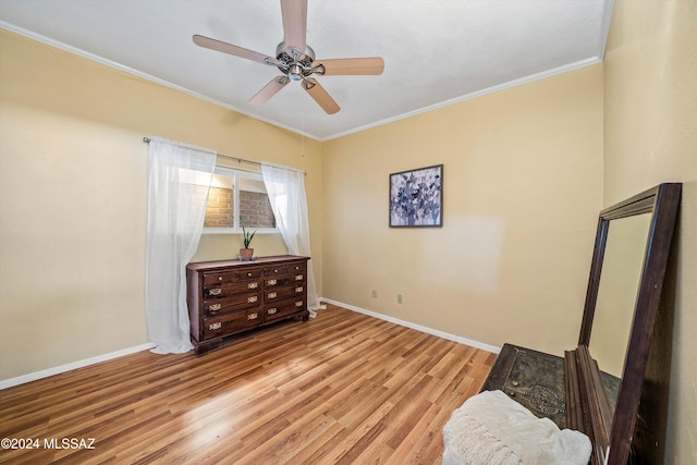 bedroom featuring ceiling fan, light wood-type flooring, and ornamental molding