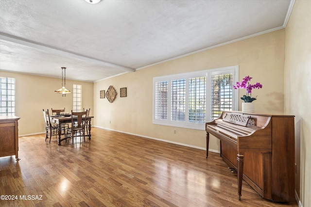 interior space with ornamental molding, a textured ceiling, and hardwood / wood-style flooring