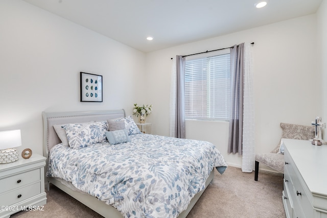 bedroom featuring light carpet