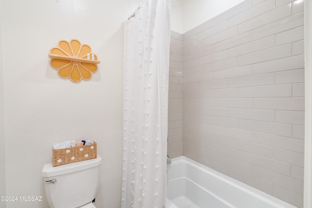 bathroom with shower / tub combo and toilet