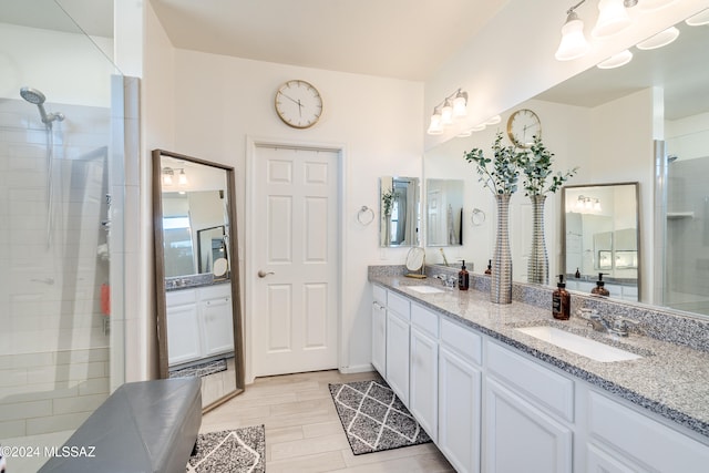 bathroom featuring vanity, hardwood / wood-style flooring, and a shower with shower door