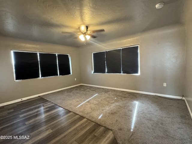 spare room with ceiling fan, a textured ceiling, and wood-type flooring