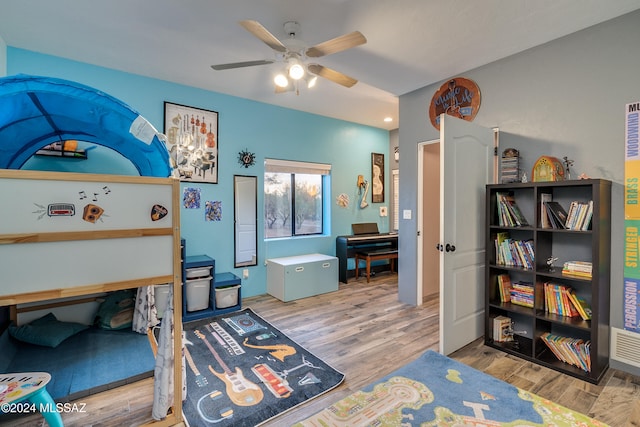 bedroom with light hardwood / wood-style flooring and ceiling fan