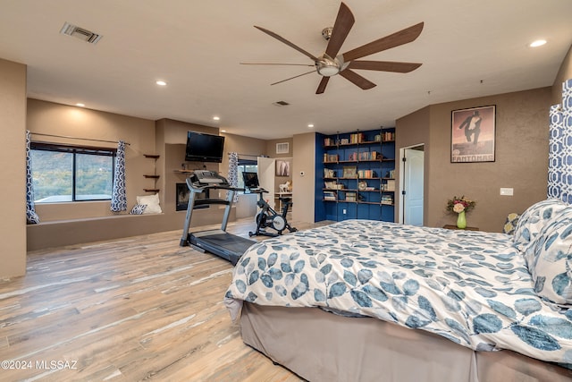 bedroom with ceiling fan and hardwood / wood-style floors