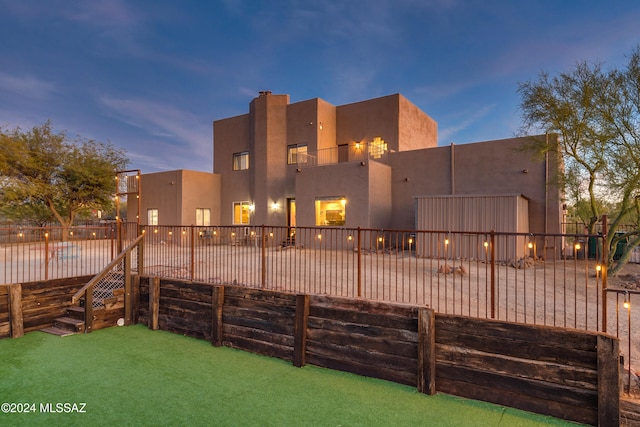 view of back house at dusk