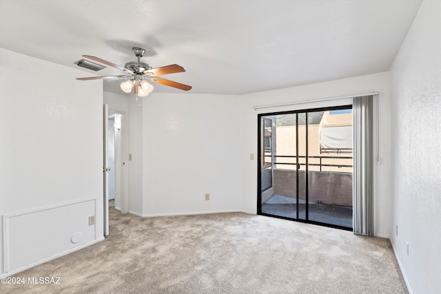 carpeted spare room featuring ceiling fan