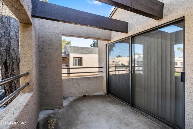 view of patio featuring a balcony