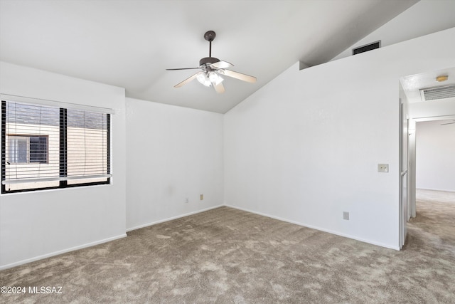 empty room featuring ceiling fan, light colored carpet, and vaulted ceiling