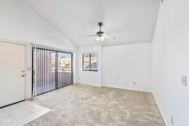 carpeted empty room with high vaulted ceiling and ceiling fan