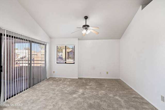 carpeted empty room featuring vaulted ceiling and ceiling fan