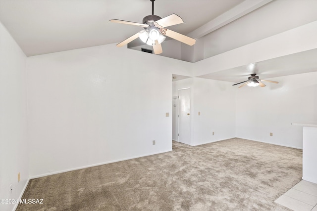 carpeted empty room featuring ceiling fan and high vaulted ceiling