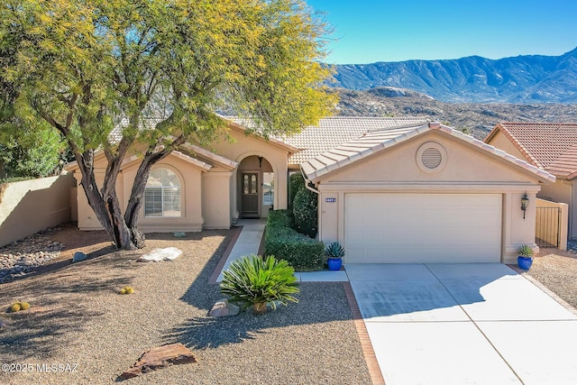 view of front of property featuring a garage and a mountain view