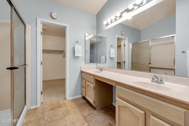 bathroom featuring an enclosed shower and vanity