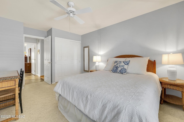 carpeted bedroom with ceiling fan and a closet