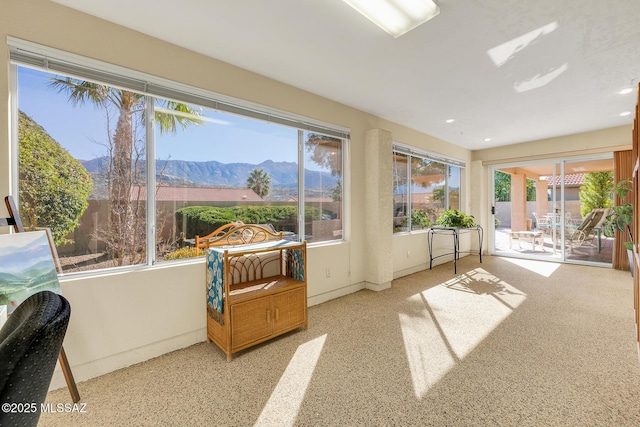 sunroom / solarium with a wealth of natural light and a mountain view