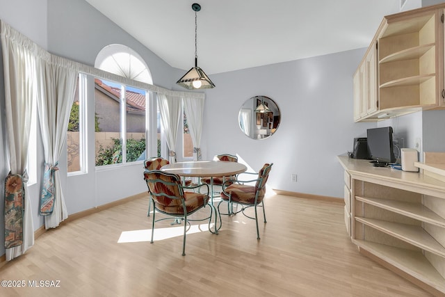 dining space featuring light hardwood / wood-style floors and lofted ceiling