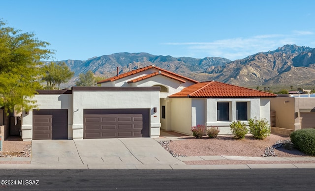 mediterranean / spanish house with a mountain view and a garage