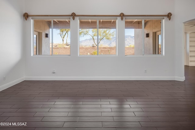 empty room featuring dark hardwood / wood-style flooring