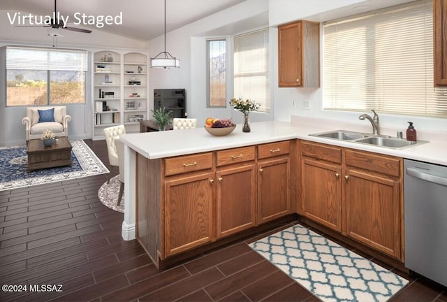 kitchen featuring dishwasher, pendant lighting, dark hardwood / wood-style floors, and sink